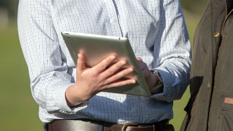 Hands holding an iPad.