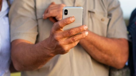 Hand holding mobile phone.