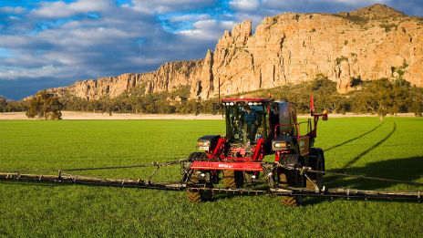 Tractor working a paddock in front of Mt Arapiles.