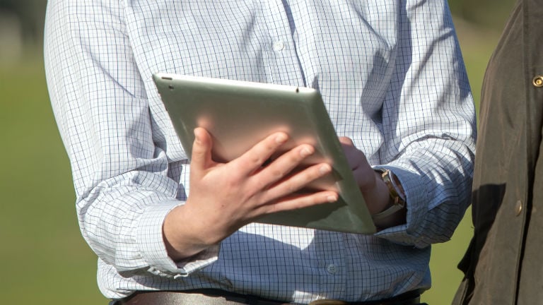 Hands holding an iPad.