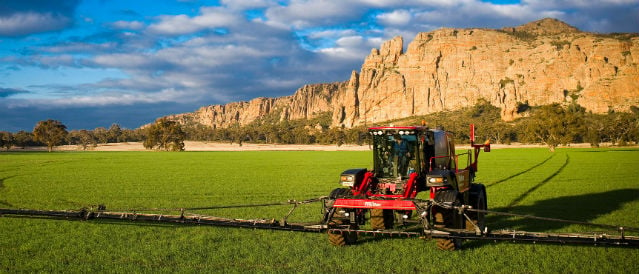 Tractor working a paddock in front of Mt Arapiles.