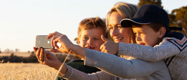 Mother and her two sons taking a selfie.